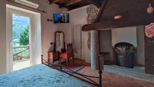 a bedroom with a bed and a tv on the wall at B&B la Curt del Böff in Lasnigo