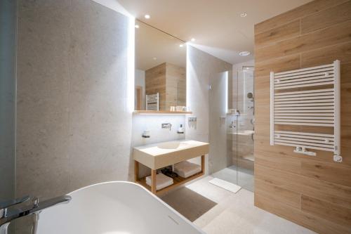 a bathroom with a white sink and a shower at Kapka resort in Vsetín
