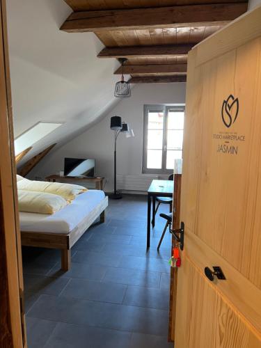 a bedroom with a bed and a desk in a room at Studio JASMINE interlaken in Interlaken