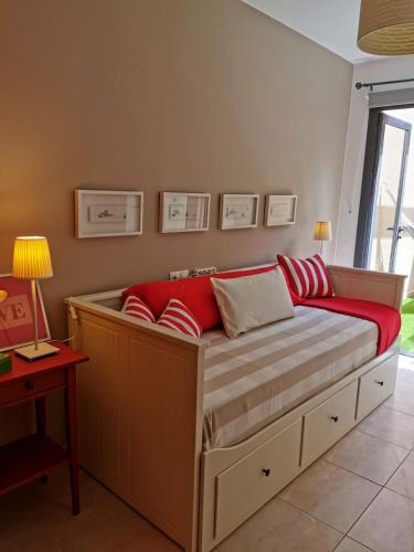 a bedroom with a bed with red and white pillows at My place in Cotillo 6 in El Cotillo