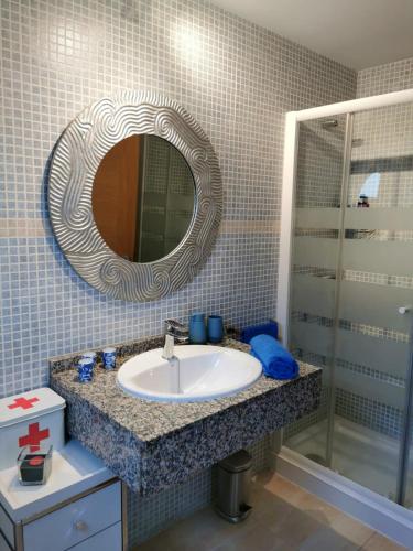 a bathroom with a sink and a mirror at My place in Cotillo 6 in El Cotillo