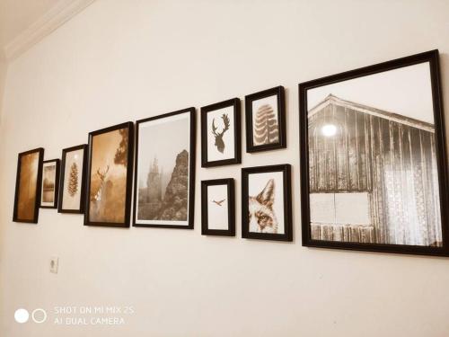 a group of pictures hanging on a wall at Evaggelia's Apartments 1 Διαμονή στο κέντρο in Kozani