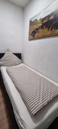 a bed in a room with a picture on the wall at SM3 Apartment in Triberg