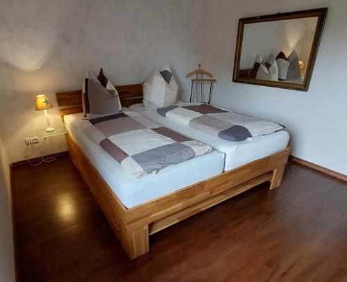 a large bed in a room with a mirror at Ferienwohnung sunset Weissenstadt in Weißenstadt