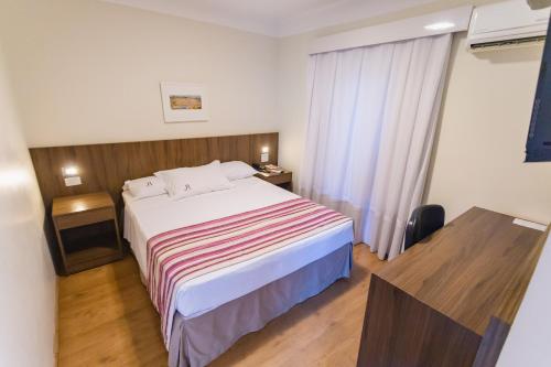 Postel nebo postele na pokoji v ubytování JR Hotel Ribeirão Preto