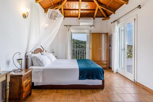 a bedroom with a bed and a large window at Villa Rose in Glossa