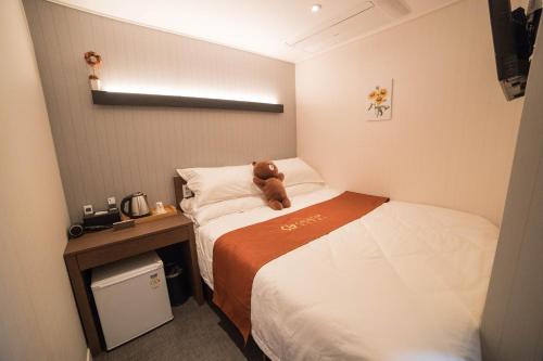a hotel room with a teddy bear sitting on a bed at Calistar Hotel in Seoul