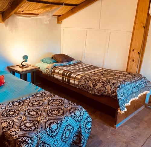 Postel nebo postele na pokoji v ubytování Las Cabañas de Ana