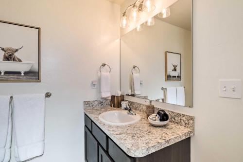 a bathroom with a sink and a mirror at Kalispell Home with 2 Suites about 35 Mi to Glacier in Kalispell