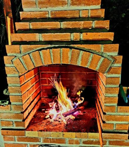 a brick oven with a fire inside of it at Old Mark's House Sinaia in Sinaia