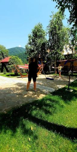 a person standing on a sidewalk with a kite at Old Mark's House Sinaia in Sinaia