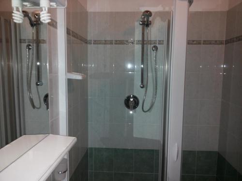 a bathroom with a shower with a glass door at Hotel Le Querce in Milan