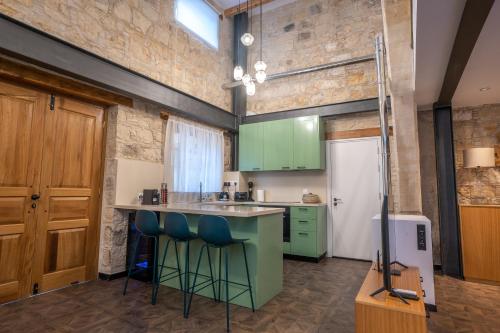 a kitchen with green cabinets and a white refrigerator at Palazzino Luxury Suites in Lofou