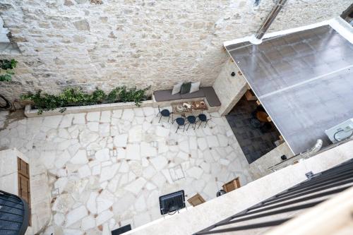 an overhead view of a building with a table and chairs at Palazzino Luxury Suites in Lofou