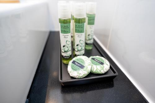 a shelf with some bottles of lotion on it at Palazzino Luxury Suites in Lofou