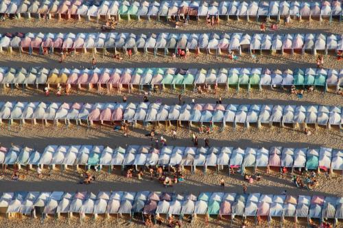 an overhead view of a beach with beach umbrellas at Feel Nazaré - Boutique Apartments in Nazaré