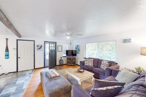 a living room with a couch and a table at Coastal Calm in Lincoln City