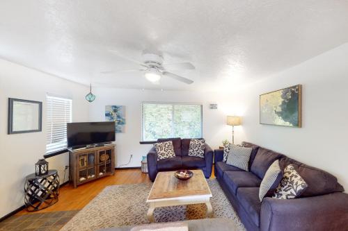 a living room with a couch and a tv at Coastal Calm in Lincoln City