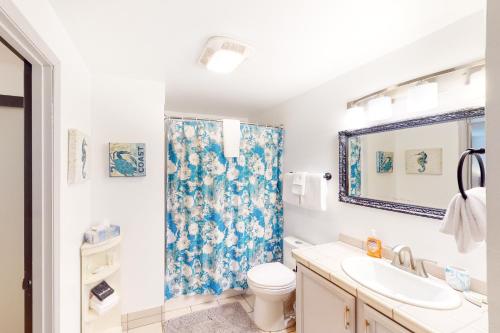 a bathroom with a sink and a toilet and a shower at Coastal Calm in Lincoln City