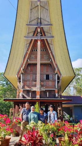 a group of people standing in front of a church at Toraja Homestay & Coffee Bunna in Rantepao