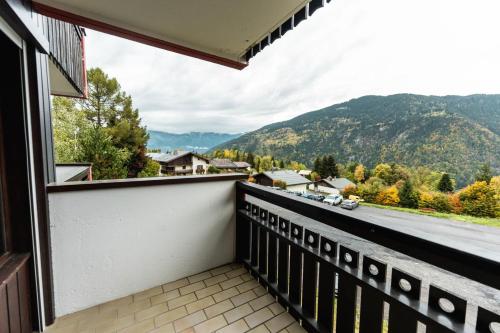 a balcony with a view of a road and mountains at Nice Studio with balcony ski-in ski-out chairlift 5 mins walk in Saint-Gervais-les-Bains