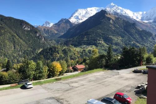 a parking lot with mountains in the background at Nice Studio with balcony ski-in ski-out chairlift 5 mins walk in Saint-Gervais-les-Bains