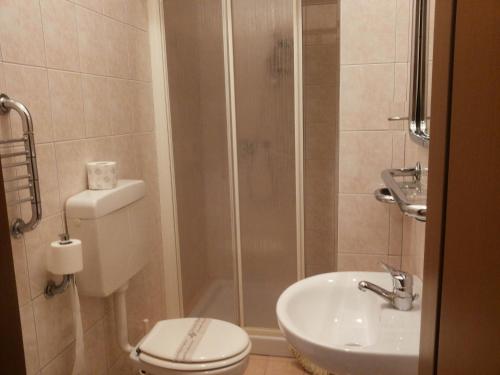 a bathroom with a shower and a toilet and a sink at Hotel Le Querce in Milan
