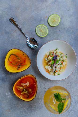 a table with three plates of food and a bowl of soup at Suitree Experience Hotel in Guanacaste