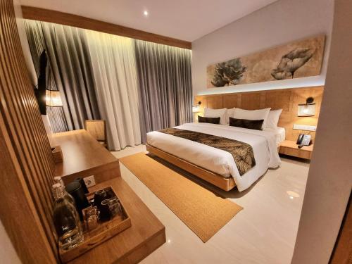 a bedroom with a large bed in a room at Truntum Boutique Mandalika in Kuta Lombok