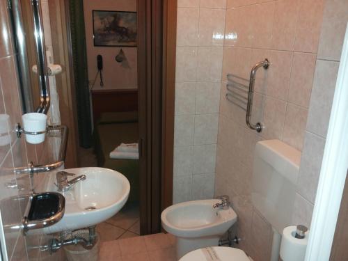 a bathroom with a toilet and a sink at Hotel Le Querce in Milan
