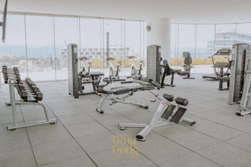 a gym with rows of treadmills and machines at Máritima Golf New apartment private beach access in Nuevo Vallarta 