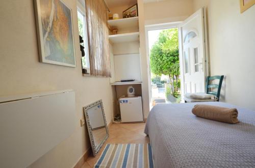 a bedroom with a bed and a mirror on the floor at Apartments Mirta in Rovinj