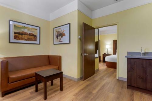 a hotel room with a couch and a bed at Best Western Phoenix Goodyear Inn in Goodyear