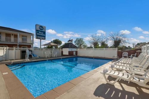 a swimming pool with lounge chairs and a hotel at Best Western Butch Cassidy Inn in Beaver