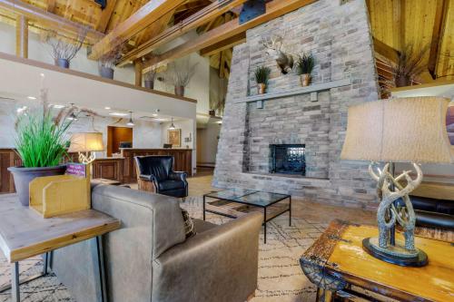 a living room with a couch and a stone fireplace at Best Western PLUS Bryce Canyon Grand Hotel in Bryce Canyon