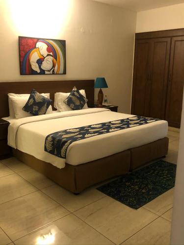 a bedroom with a large bed in a room at The Neem in New Delhi