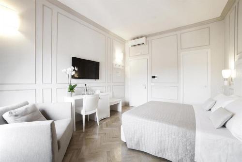 a hotel room with white walls and white furniture at Residenza Scipioni Luxury B&B in Rome