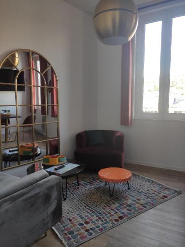 a living room with a couch and a table at LE REFLET DES VOILES FACE AU PORT DE FECAMP in Fécamp