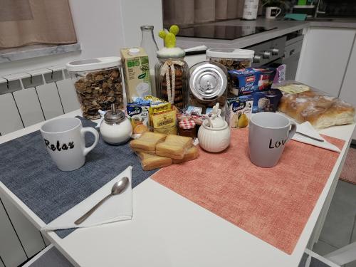 a table with coffee cups and food on it at Casa Monì in Naples