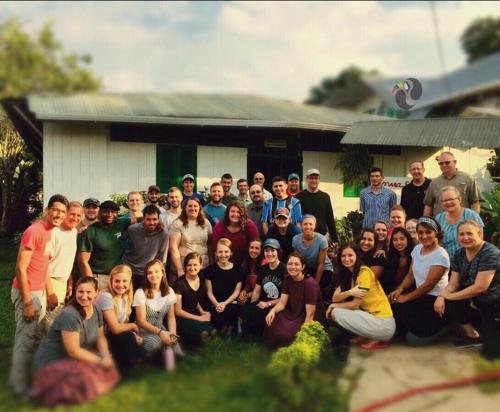 a group of people posing for a picture in front of a house at Hotel Lomas del Paiyü in Puerto Nariño