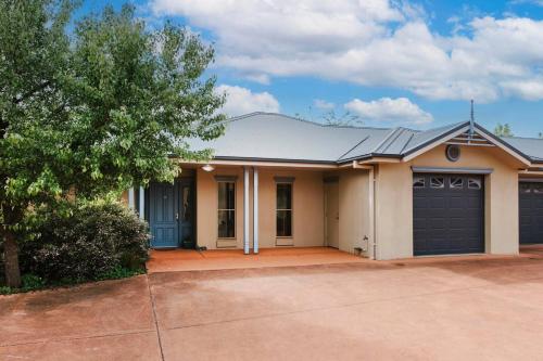 a house with a garage and a driveway at Nikki's on Market St - A Central Country Abode in Mudgee