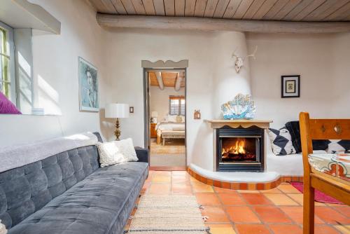 a living room with a couch and a fireplace at Besos on Canyon Road in Santa Fe