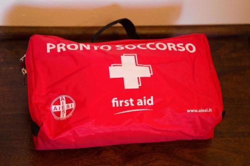 a red first aid bag sitting on a table at Appartamento con giardino e parcheggio privato in Bellagio