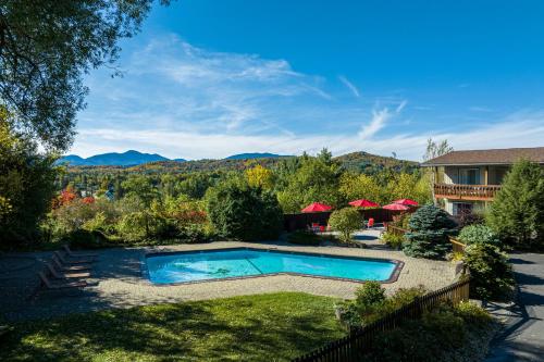 a backyard with a swimming pool and a house at The Devlin in Lake Placid
