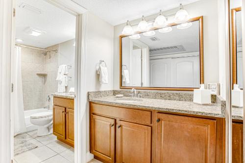 a bathroom with a sink and a toilet and a mirror at 255-56 Sandcastles in Fernandina Beach