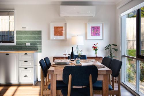 a dining room with a table and chairs at Indus- a bright and welcoming home in Daylesford