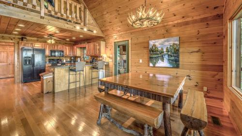 a dining room with a table and a kitchen at Finding Grace in Blue Ridge