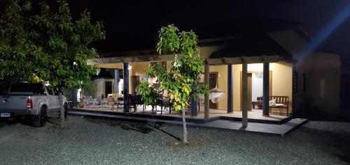 a small tree in front of a house at night at Villa Rosalía Jarabacoa con Piscina Climatizada in Jarabacoa
