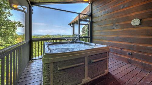 a hot tub on the deck of a house at Finding Grace in Blue Ridge