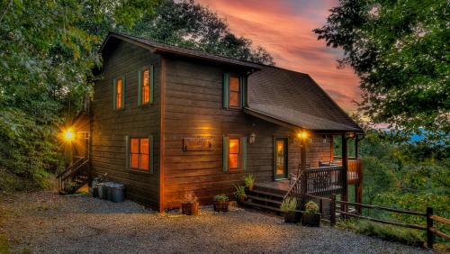 a small wooden house with a sunset in the background at Finding Grace in Blue Ridge